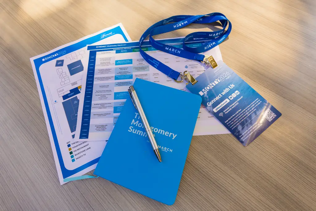 A Summit badge, lanyard and notebook on a table